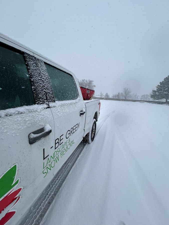 Truck and spreader on a snowy route