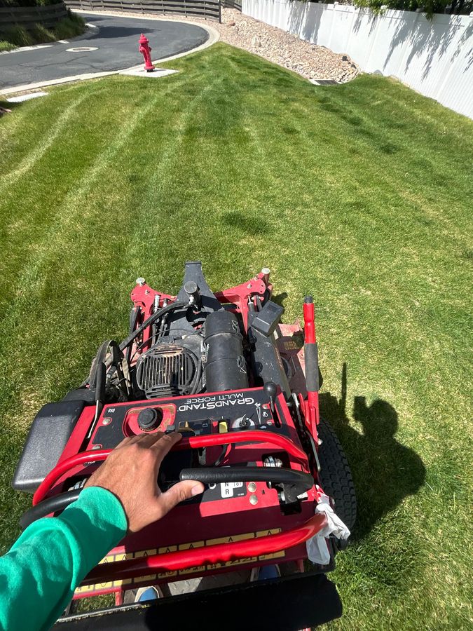 Striping a lawn with a stand-on mower