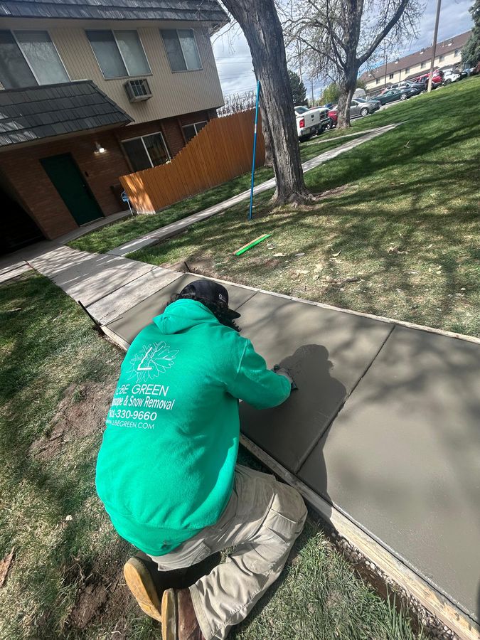 Finishing a new concrete sidewalk