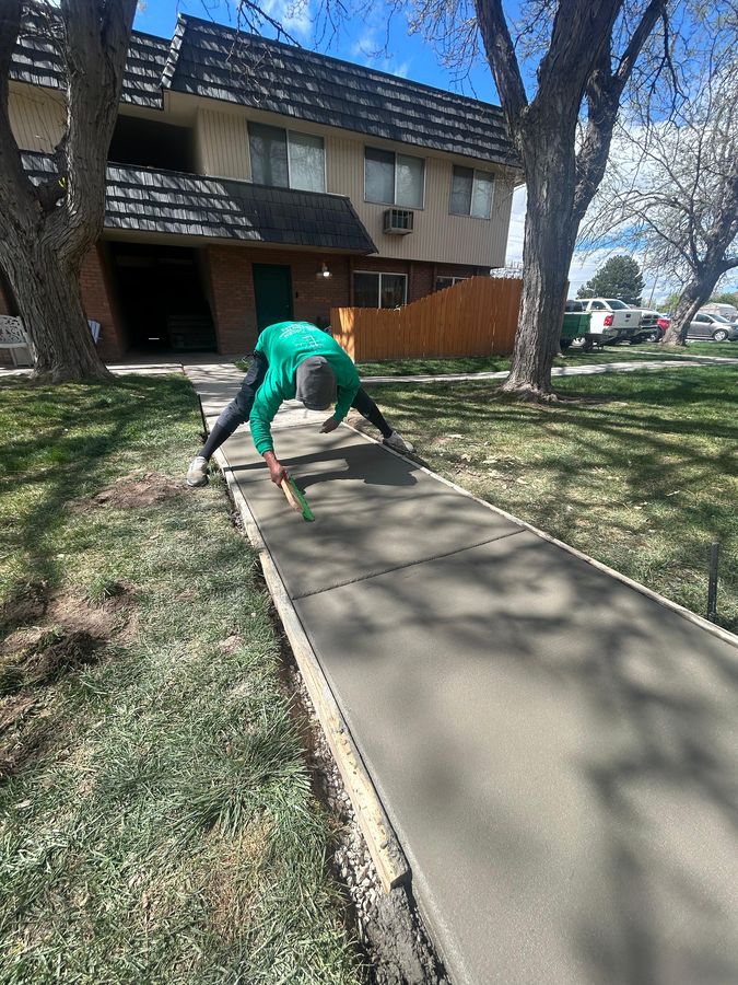 Broom-finishing a concrete walkway