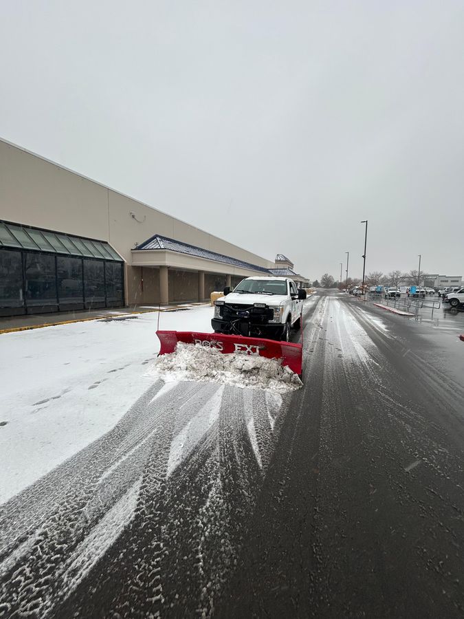 Plowing a commercial parking lot in snow